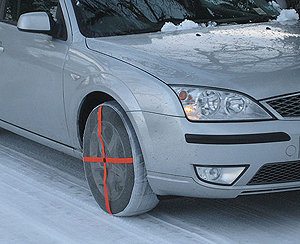 Silver car with AutoSock snow socks on